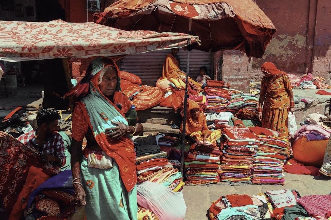 A woman standing in front of a pile of cloths