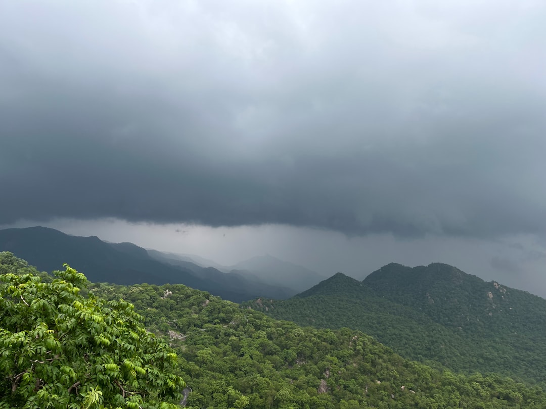 a view of a mountain range under a cloudy sky